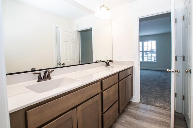 415 Kensington Ct Unit Lt128Adams, Williams Bay, WI 53191 - bathroom featuring double vanity and wood finished floors