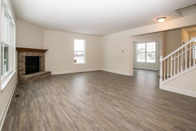415 Kensington Ct Unit Lt128Adams, Williams Bay, WI 53191 - unfurnished living room featuring dark wood finished floors, stairway, and a brick fireplace