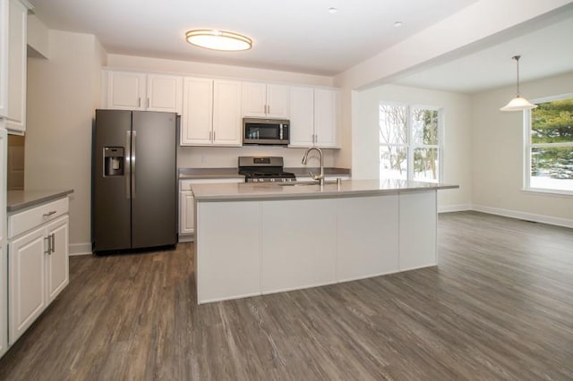 415 Kensington Ct Unit Lt128Adams, Williams Bay, WI 53191 - kitchen featuring appliances with stainless steel finishes, white cabinetry, dark wood-type flooring, decorative light fixtures, and a center island with sink