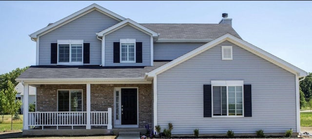 413 Kensington Ct Unit Lt129Roosevelt, Williams Bay, WI 53191 - traditional-style house featuring covered porch, brick siding, roof with shingles, and a chimney