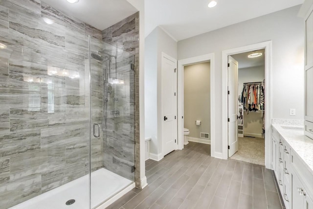 9335 223rd Ave, Salem, WI 53168 - full bathroom featuring a shower stall, vanity, a walk in closet, wood finished floors, and recessed lighting