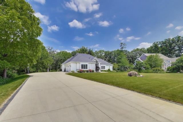 9335 223rd Ave, Salem, WI 53168 - ranch-style home with a garage, a front lawn, concrete driveway, and view of wooded area