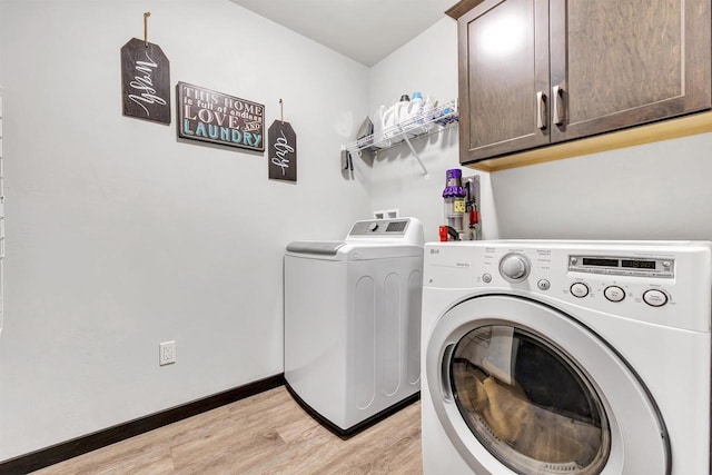 582 Clay St, Wrightstown, WI 54180 - laundry room featuring washer and clothes dryer, cabinet space, and light wood-type flooring