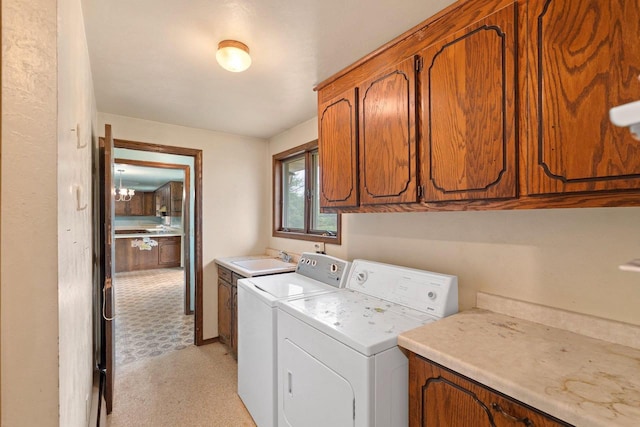 1490 Fernando Dr, Ashwaubenon, WI 54115 - laundry area featuring cabinet space, washer and clothes dryer, light flooring, and a chandelier