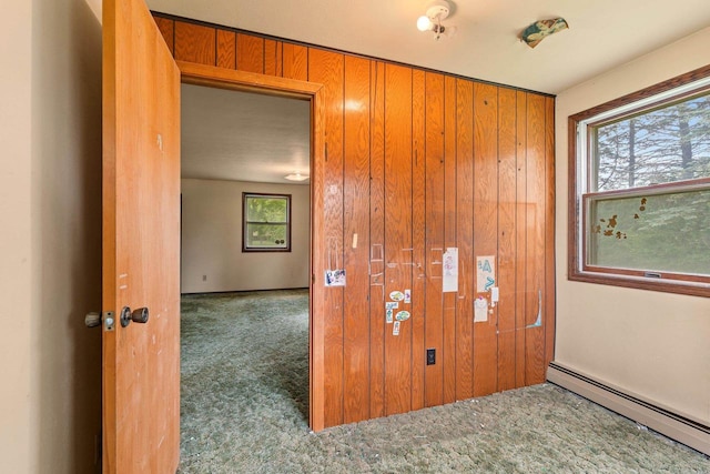 1490 Fernando Dr, Ashwaubenon, WI 54115 - carpeted empty room featuring a baseboard heating unit and wooden walls
