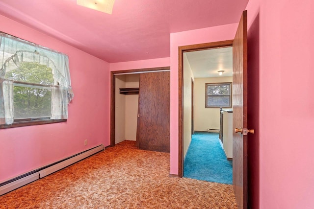 1490 Fernando Dr, Ashwaubenon, WI 54115 - unfurnished bedroom featuring baseboard heating, carpet, and a closet