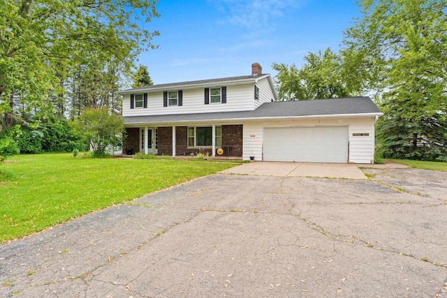 1490 Fernando Dr, Ashwaubenon, WI 54115 - traditional-style house with a chimney, a garage, driveway, a front lawn, and a porch