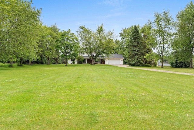 1490 Fernando Dr, Ashwaubenon, WI 54115 - view of green lawn with a garage and driveway