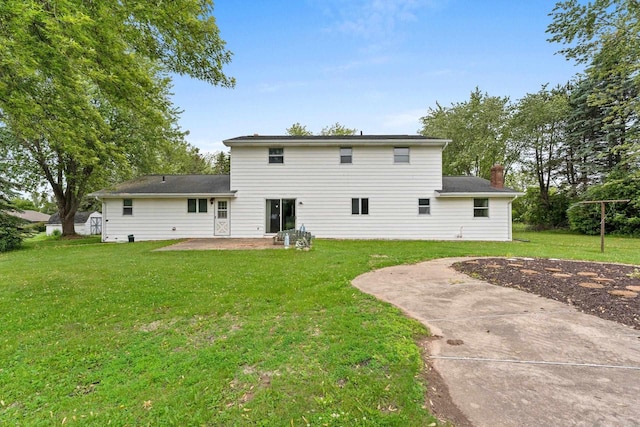 1490 Fernando Dr, Ashwaubenon, WI 54115 - back of property featuring a patio area, a yard, and a chimney