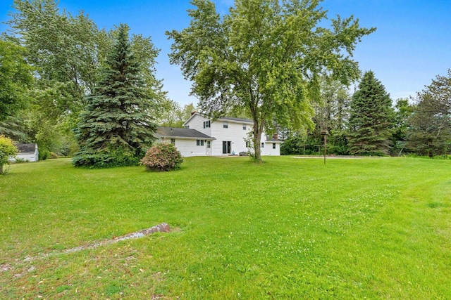 1490 Fernando Dr, Ashwaubenon, WI 54115 - view of green lawn featuring a garage