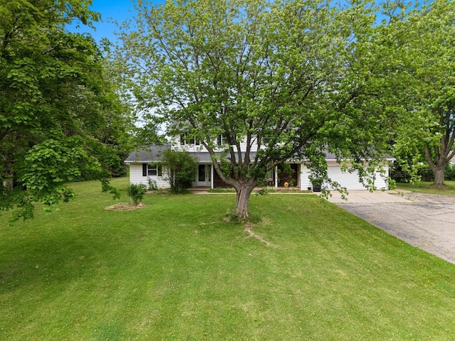 1490 Fernando Dr, Ashwaubenon, WI 54115 - view of property hidden behind natural elements with concrete driveway, a front lawn, and a garage
