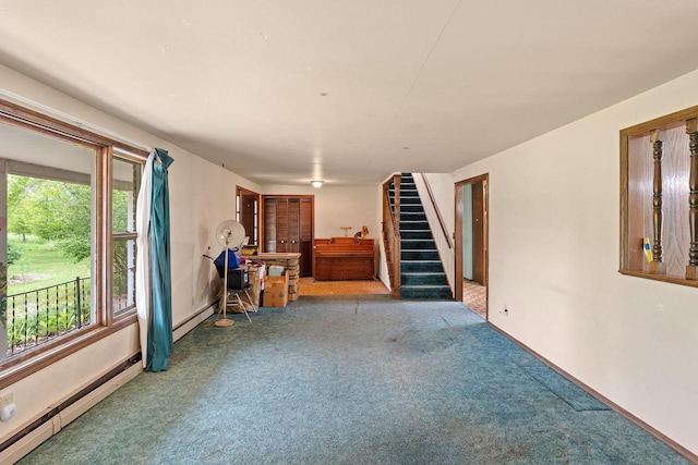 1490 Fernando Dr, Ashwaubenon, WI 54115 - unfurnished living room featuring carpet floors, a baseboard radiator, stairway, and healthy amount of natural light