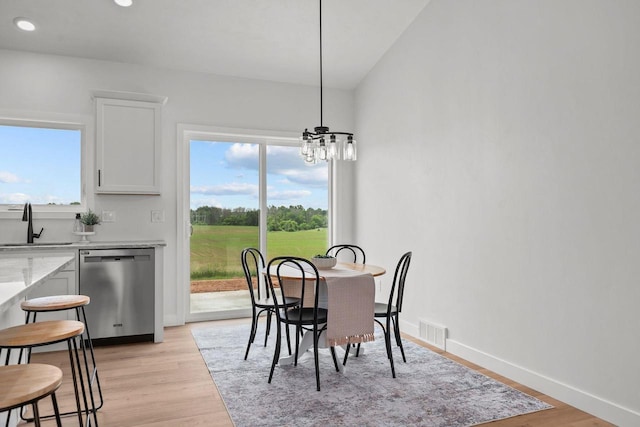 2061 White Dove Ln, Kaukauna, WI 54130 - dining room with light wood-type flooring, a chandelier, and recessed lighting