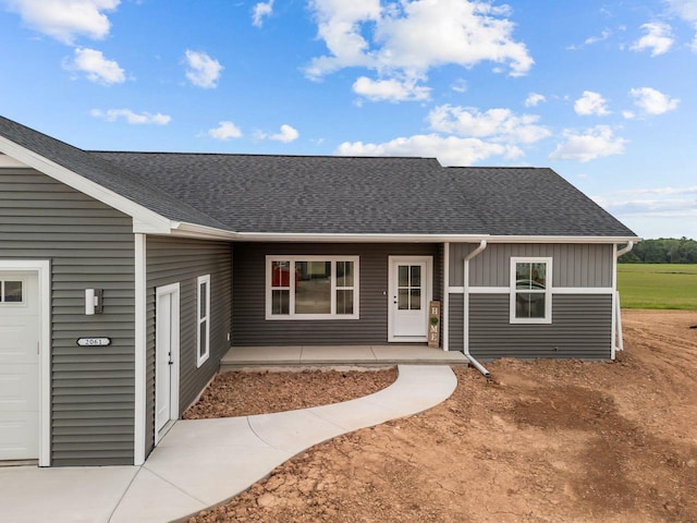 2061 White Dove Ln, Kaukauna, WI 54130 - view of front facade featuring a garage, board and batten siding, and roof with shingles