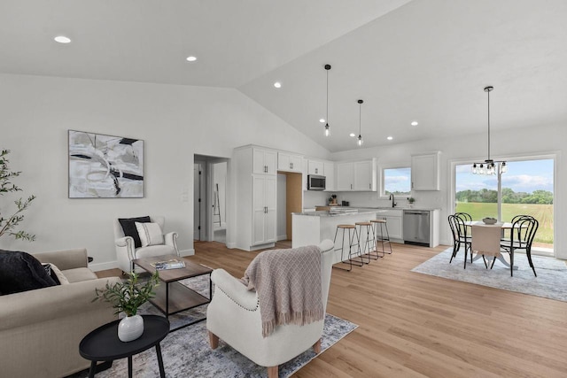 2061 White Dove Ln, Kaukauna, WI 54130 - living area with light wood-style floors, high vaulted ceiling, recessed lighting, and a chandelier