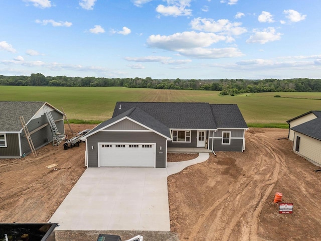 2061 White Dove Ln, Kaukauna, WI 54130 - view of front facade featuring driveway, a garage, and view of scattered trees