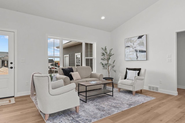 2061 White Dove Ln, Kaukauna, WI 54130 - living room featuring light wood-style floors, plenty of natural light, and lofted ceiling