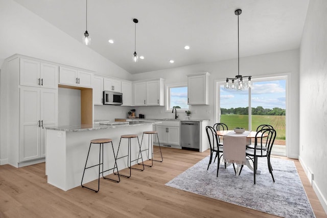 2061 White Dove Ln, Kaukauna, WI 54130 - kitchen with stainless steel appliances, a center island, white cabinetry, light wood-style floors, and recessed lighting