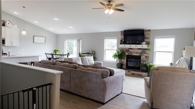 406 S Birch St, Marshfield, WI 54449 - living area with wood finished floors, a stone fireplace, a ceiling fan, and lofted ceiling