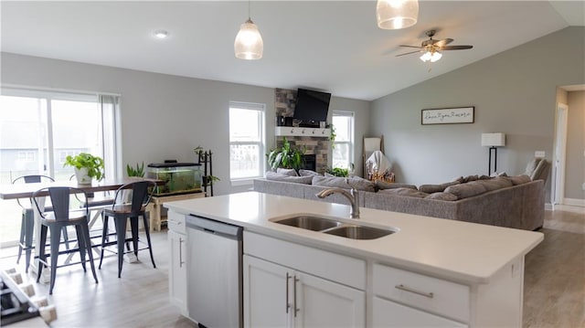 406 S Birch St, Marshfield, WI 54449 - kitchen with stainless steel dishwasher, open floor plan, lofted ceiling, light wood-style flooring, and a center island with sink