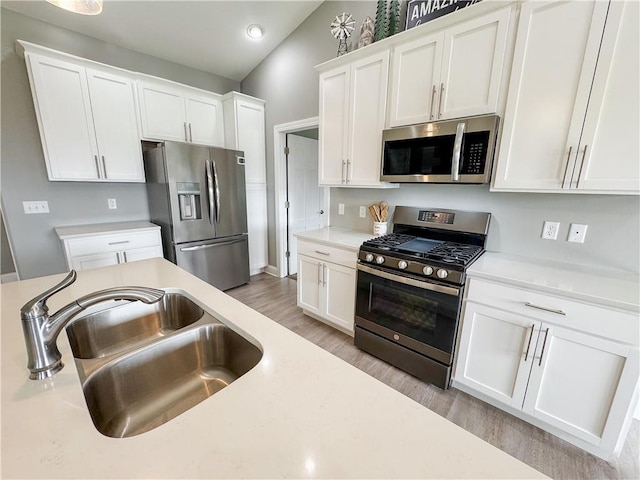 406 S Birch St, Marshfield, WI 54449 - kitchen with stainless steel appliances, light wood-style floors, light countertops, white cabinetry, and recessed lighting