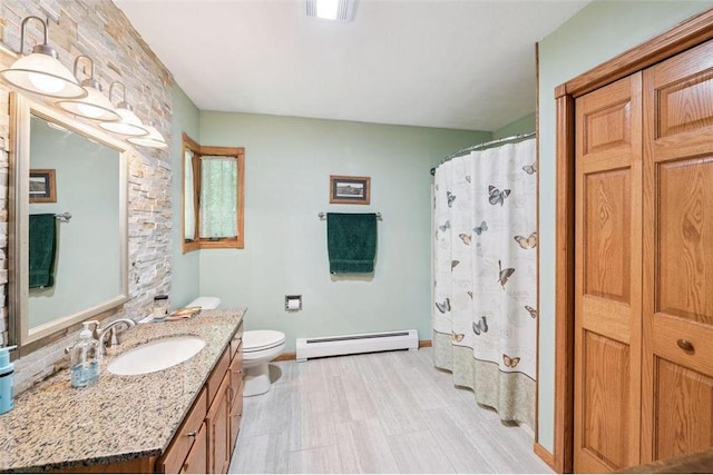 62405 Delta Lake Rd, Iron River, WI 54847 - bathroom with baseboard heating, vanity, and curtained shower