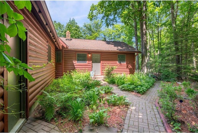 62405 Delta Lake Rd, Iron River, WI 54847 - entrance to property featuring faux log siding and a chimney