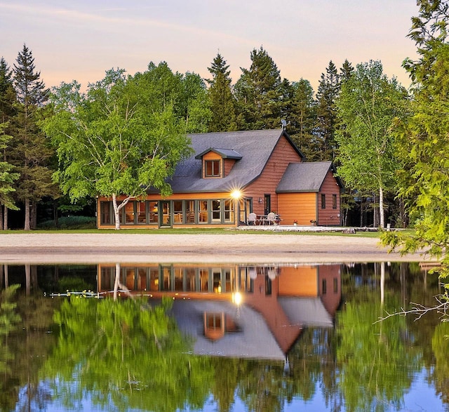 4721 Lake Of The Woods Rd, Sturgeon Bay, WI 54235 - back of property at dusk with a water view