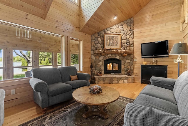 4721 Lake Of The Woods Rd, Sturgeon Bay, WI 54235 - living area with wood finished floors, wood walls, a fireplace, high vaulted ceiling, and wooden ceiling