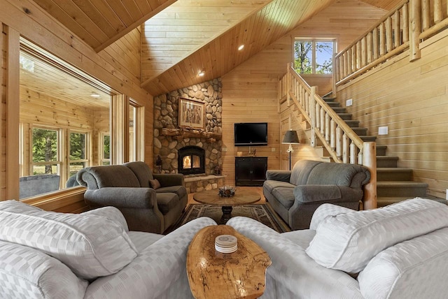 4721 Lake Of The Woods Rd, Sturgeon Bay, WI 54235 - living room with wooden walls, high vaulted ceiling, wooden ceiling, stairs, and a stone fireplace