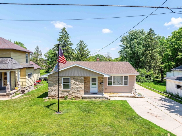 238 N State St, Chilton, WI 53014 - view of front of house with a front lawn, a porch, concrete driveway, and roof with shingles