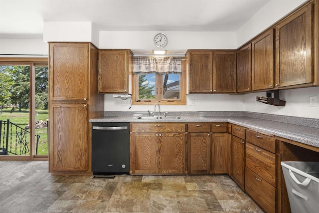 238 N State St, Chilton, WI 53014 - kitchen with dishwasher, stone finish flooring, and brown cabinets