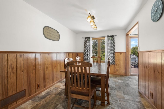 238 N State St, Chilton, WI 53014 - dining area with stone finish flooring, a wainscoted wall, and wooden walls
