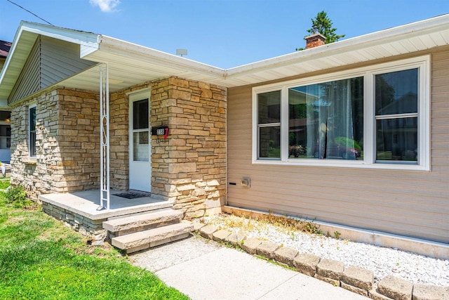 238 N State St, Chilton, WI 53014 - doorway to property with stone siding and a chimney