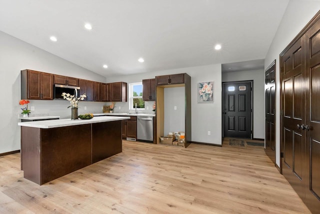 997 E Sunnyview Rd, Oshkosh, WI 54901 - kitchen with appliances with stainless steel finishes, light countertops, light wood-style floors, recessed lighting, and a kitchen island