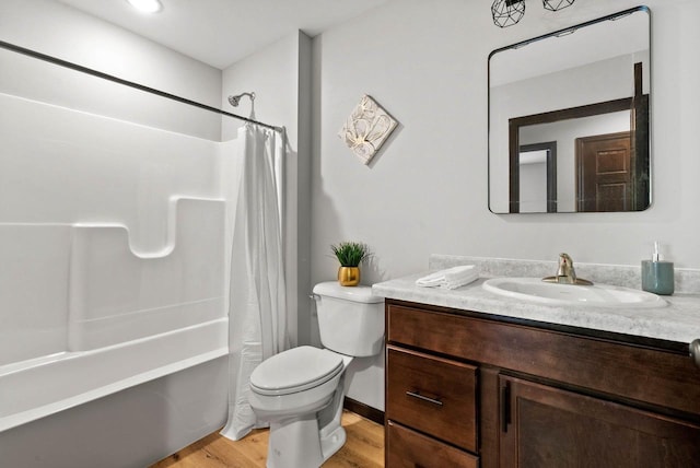 997 E Sunnyview Rd, Oshkosh, WI 54901 - full bathroom with vanity, wood finished floors, and shower / bath combo