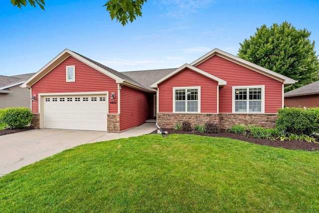 4835 Isabella Cir, Hobart, WI 54155 - ranch-style house with stone siding, a front yard, concrete driveway, and an attached garage