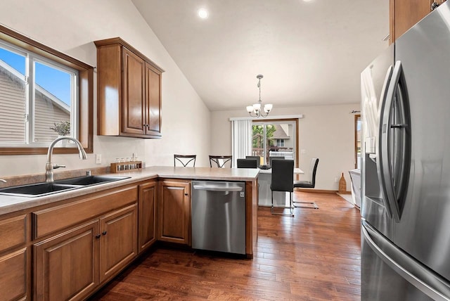 4835 Isabella Cir, Hobart, WI 54155 - kitchen with appliances with stainless steel finishes, vaulted ceiling, brown cabinets, a chandelier, and dark wood finished floors