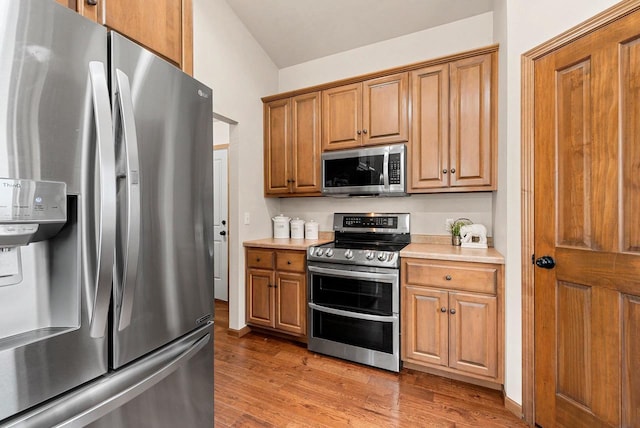 4835 Isabella Cir, Hobart, WI 54155 - kitchen with appliances with stainless steel finishes, light wood-style floors, light countertops, and brown cabinets