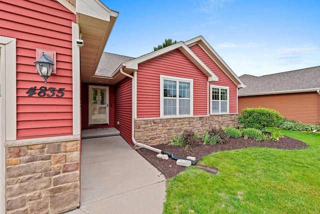 4835 Isabella Cir, Hobart, WI 54155 - view of exterior entry featuring stone siding and a yard