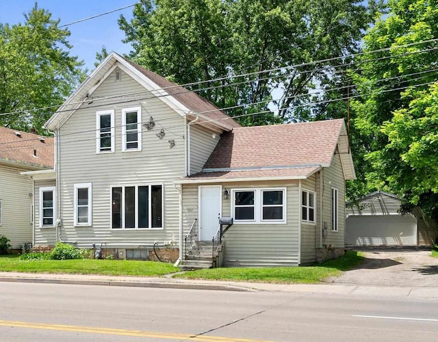 907 Lawe St, Kaukauna, WI 54130 - traditional-style home featuring entry steps, an outbuilding, and a garage