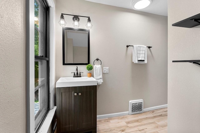 907 Lawe St, Kaukauna, WI 54130 - bathroom with plenty of natural light, wood finished floors, and vanity