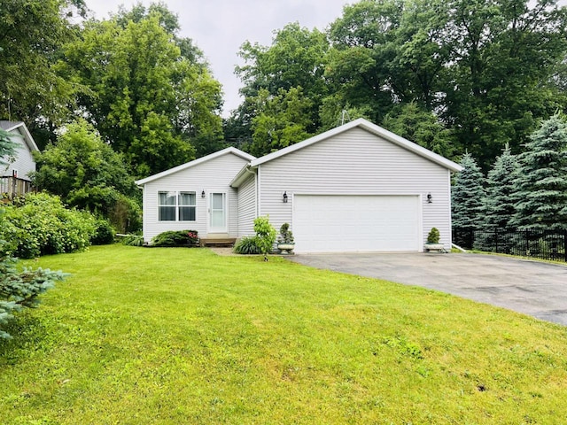 8300 Fishman Rd, Burlington, WI 53105 - view of front of property featuring asphalt driveway, a front lawn, a garage, and view of scattered trees