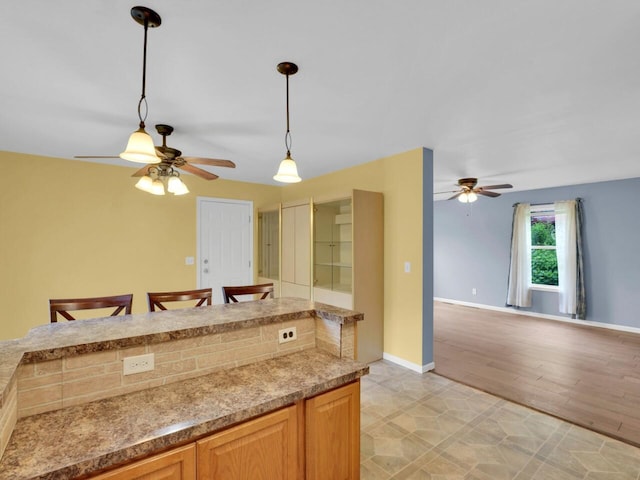 8300 Fishman Rd, Burlington, WI 53105 - kitchen with ceiling fan, pendant lighting, light countertops, and open floor plan