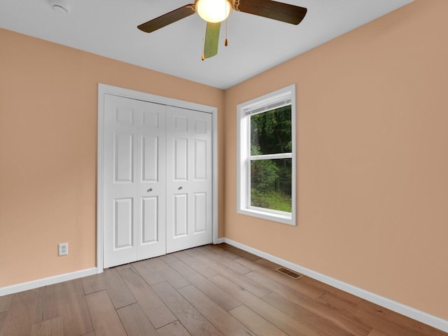 8300 Fishman Rd, Burlington, WI 53105 - unfurnished bedroom with a closet, wood finished floors, and ceiling fan