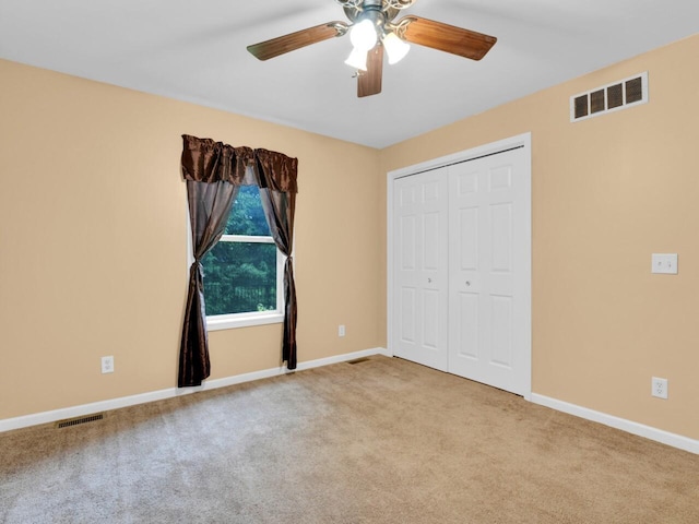 8300 Fishman Rd, Burlington, WI 53105 - unfurnished bedroom featuring carpet flooring, a closet, and a ceiling fan