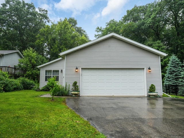 8300 Fishman Rd, Burlington, WI 53105 - view of property exterior featuring a garage, a yard, and asphalt driveway
