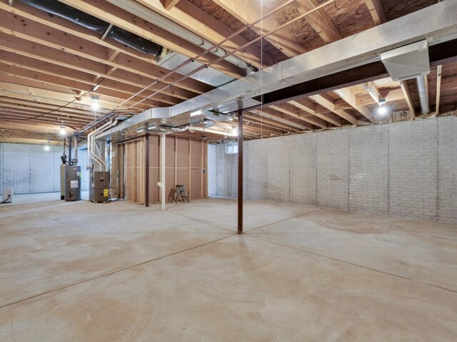 8300 Fishman Rd, Burlington, WI 53105 - unfinished basement with electric water heater and heating unit