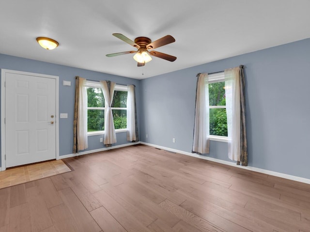 8300 Fishman Rd, Burlington, WI 53105 - foyer entrance featuring ceiling fan, healthy amount of natural light, and wood finished floors