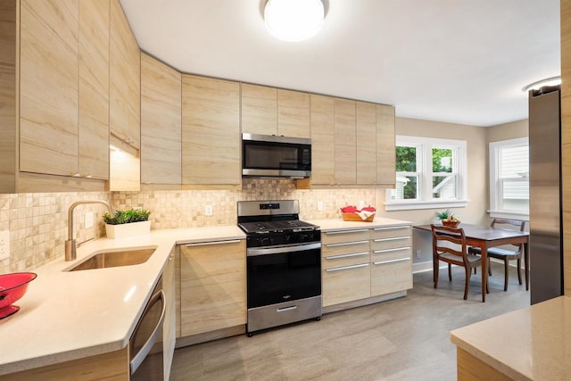 50 S Marquette St, Madison, WI 53704 - kitchen featuring stainless steel appliances, light brown cabinetry, backsplash, modern cabinets, and light countertops